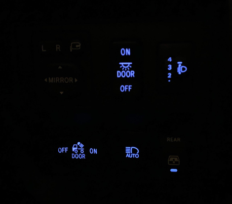 Mirror controls (top left) are not backlit at night, for whatever reason